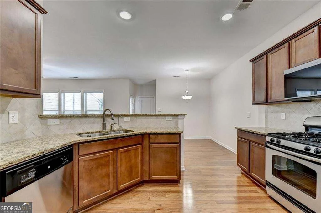 Kitchen with gas range and stainless-steel appliances