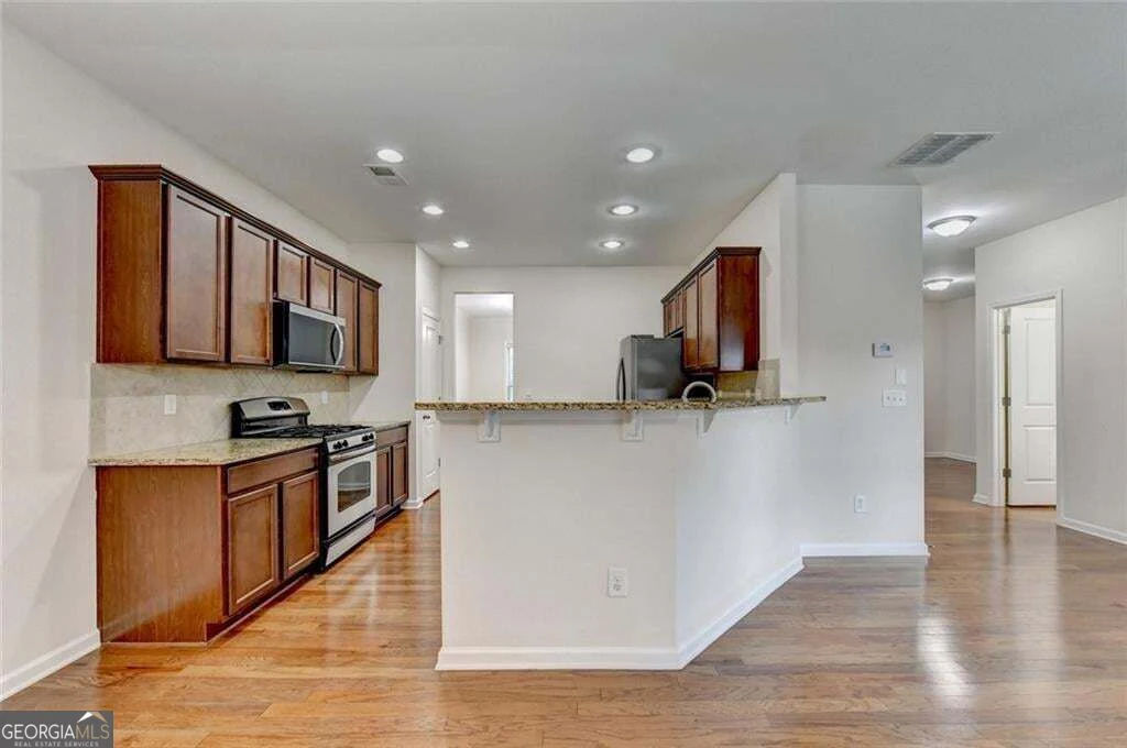 Kitchen with breakfast bar and wood cabinetry