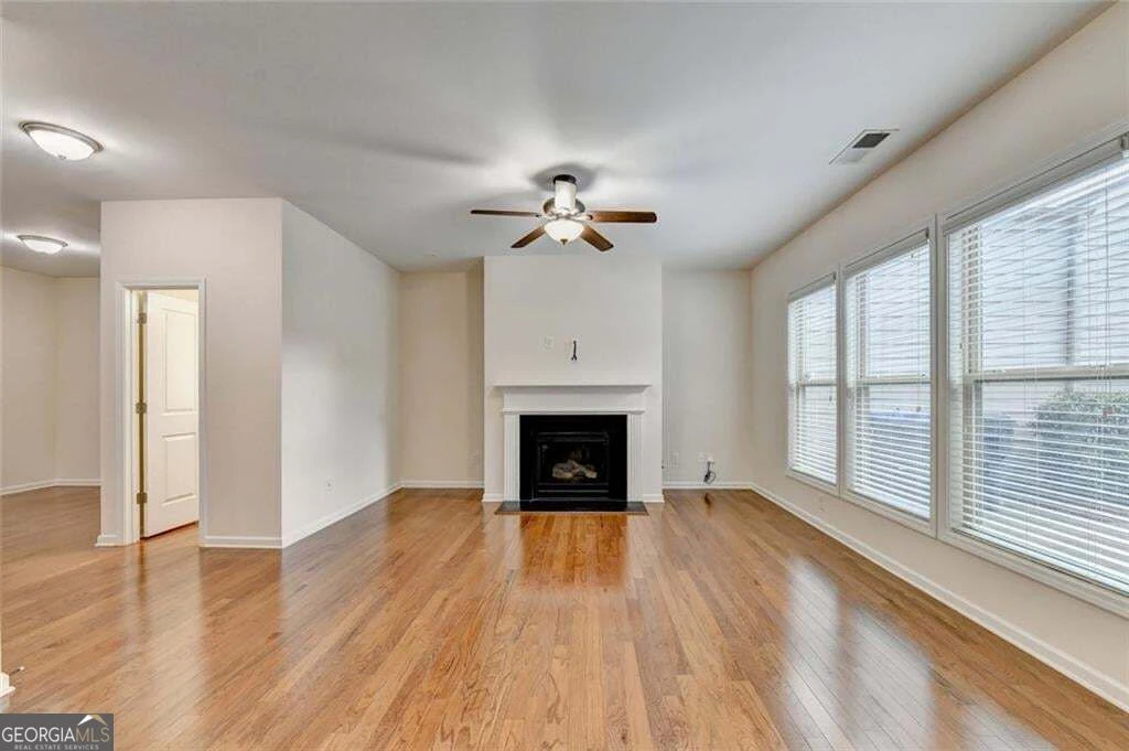 Living room with fireplace and three windows